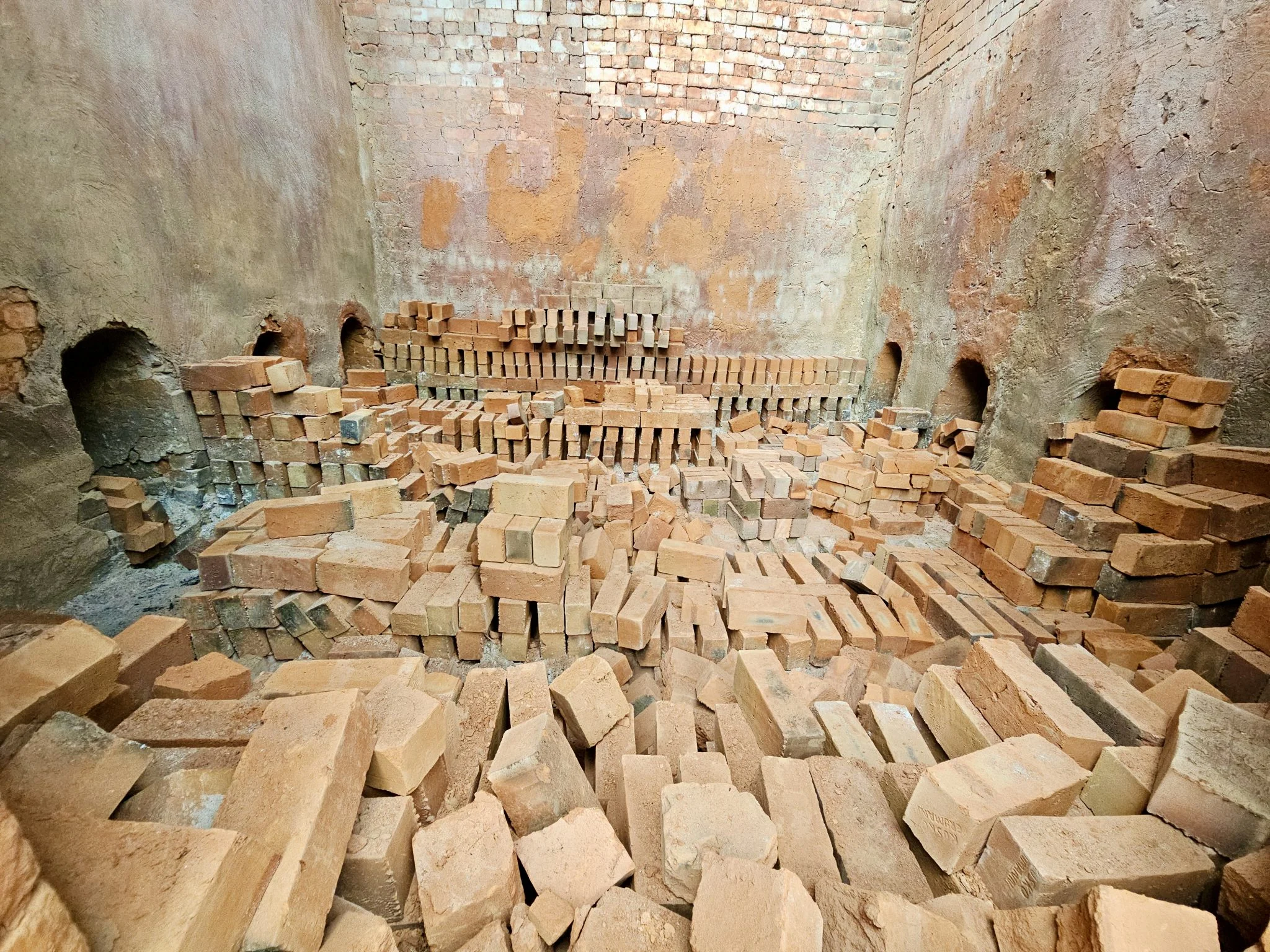 Bricks stacked inside a large kiln chamber