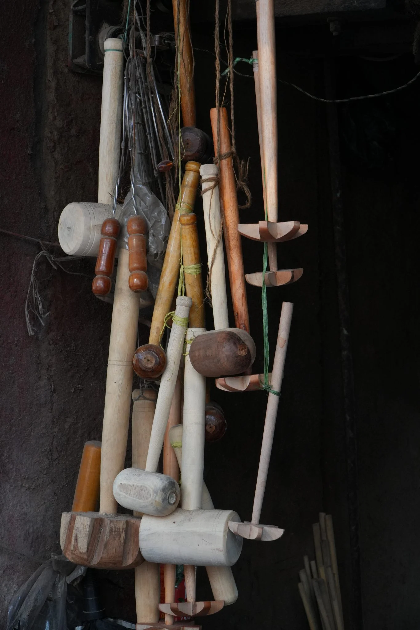 Wooden mallets and carving tools hanging in a workshop